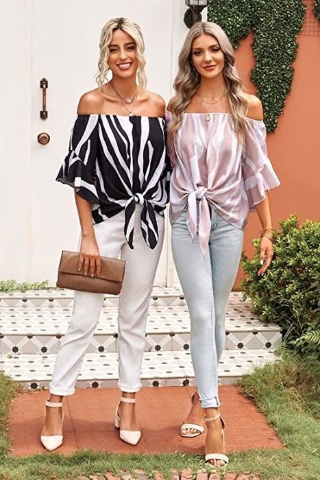 Two models showcasing the tops in black/white and light pink/white, styled with cuffed jeans and heels