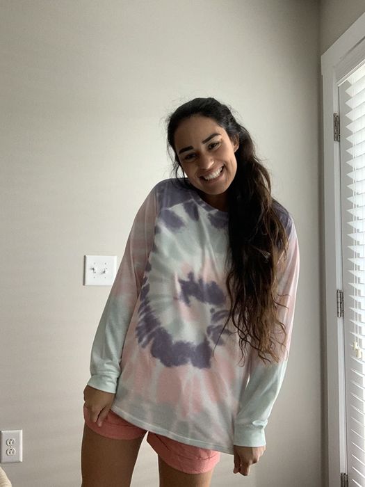 A reviewer wearing a pastel tie-dye sweatshirt.