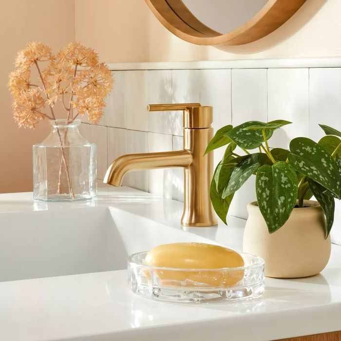 The faux plant resting on a bathroom sink