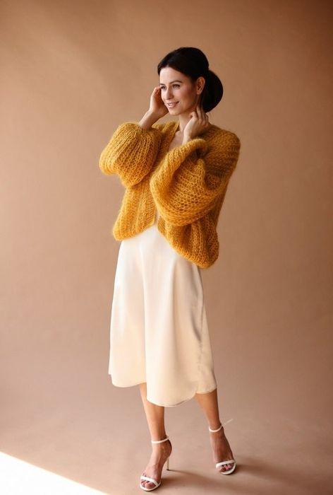 A model wearing the soft, knitted cardigan in a vibrant yellow shade.