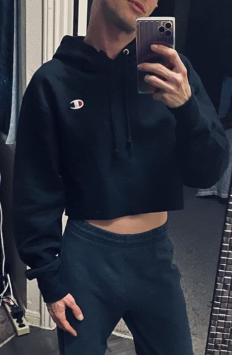 A reviewer takes a mirror selfie, showcasing a black cropped hoodie.