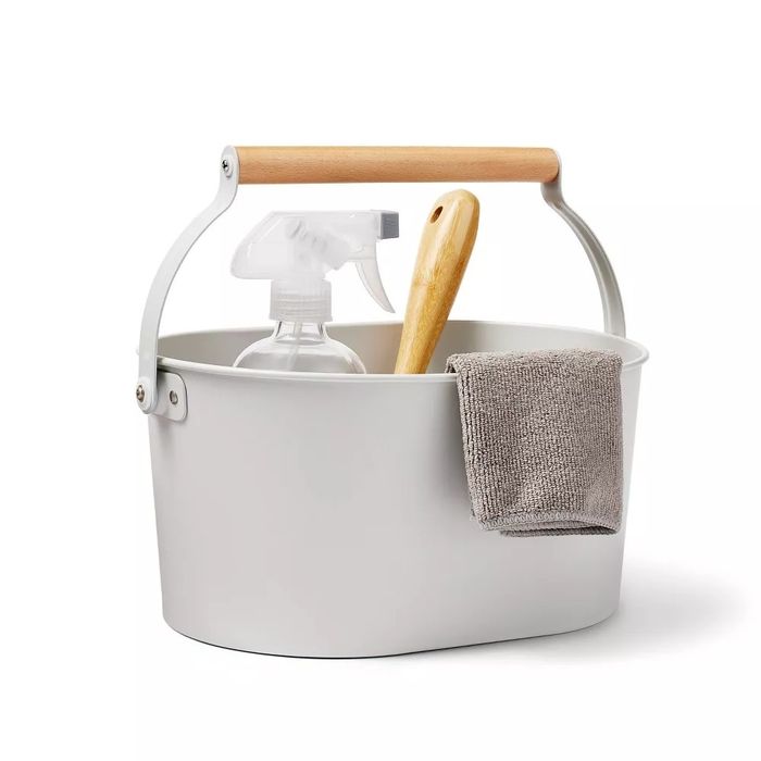 light gray cleaning caddy filled with various cleaning supplies