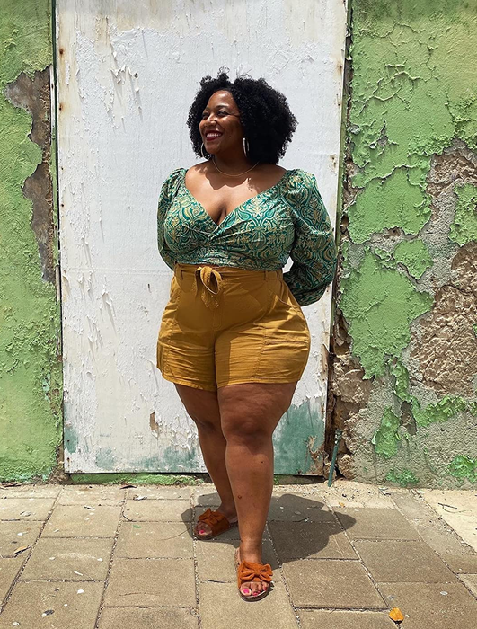A full-body image of a reviewer wearing the same top, paired with vibrant yellow shorts.