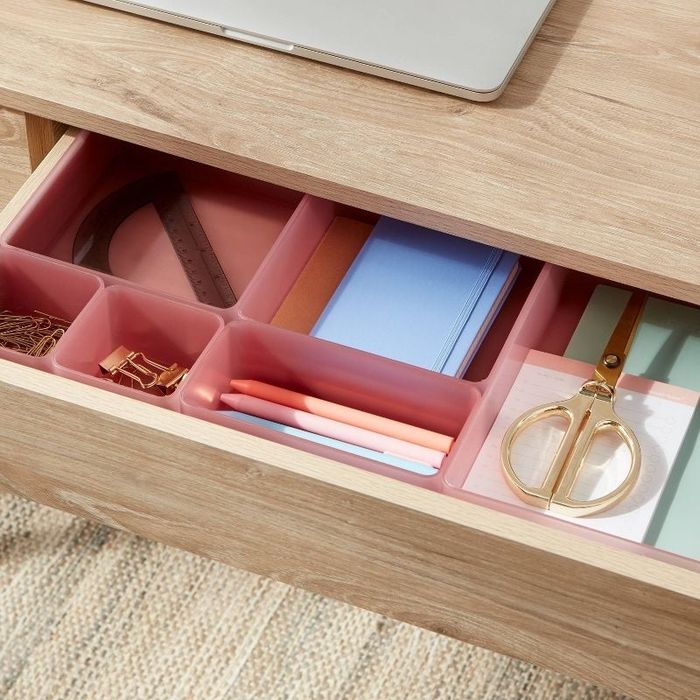 The drawer organizers neatly placed in a desk drawer