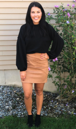 A reviewer wearing the same sweater in black