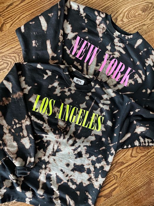 two black sweatshirts featuring acid-wash tie dye, one with