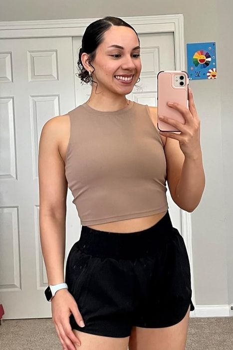 A reviewer modeling the yoga tank