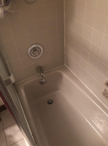 the same bathtub now appearing pristine after using the Bar Keepers Friend soft cleanser