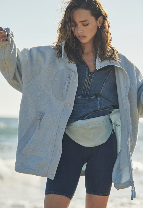 a model sporting a light blue fleece zip-up jacket