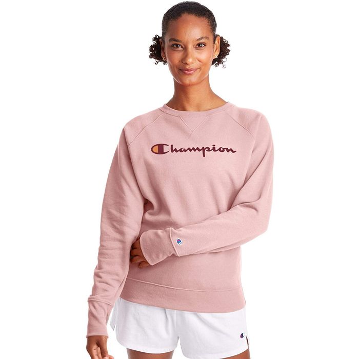 A model sporting a simple sweatshirt with the Champion logo displayed on it.