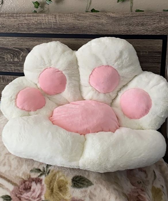 The cushion resting comfortably on a reviewer’s bed, adding a soft touch to their relaxation space.