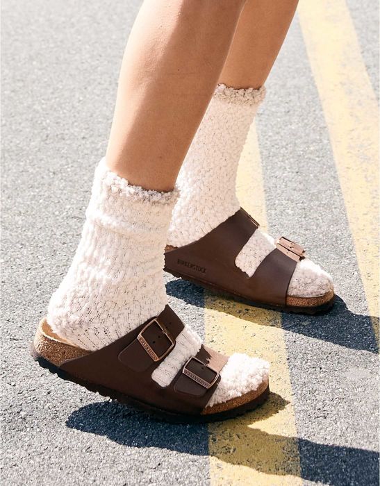 feet wearing white fuzzy crew socks and Birkenstocks