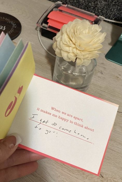 a person flipping open the book to reveal the prompt that says, 