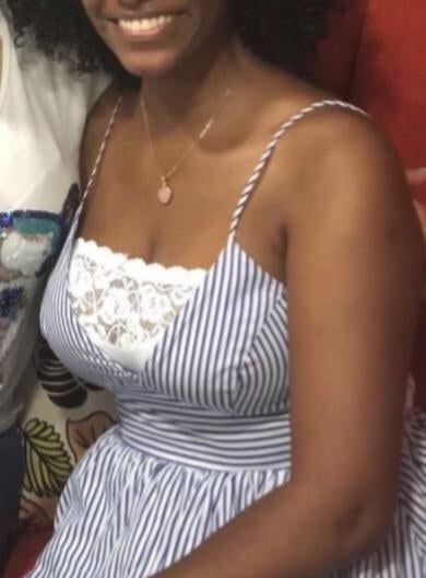 A reviewer's photo wearing the bra under a dress