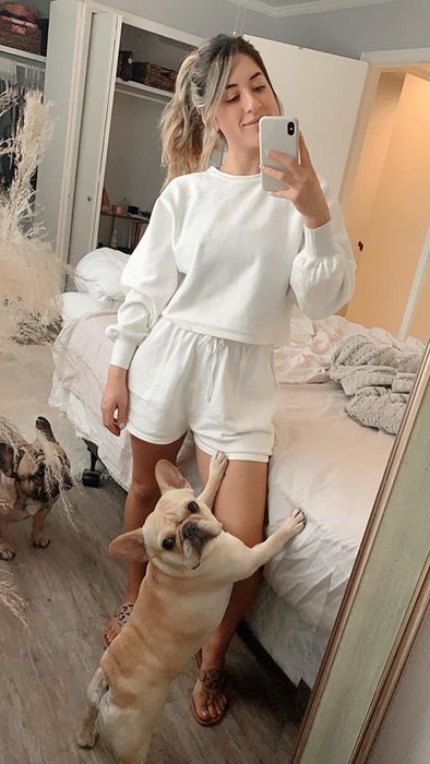 A reviewer models the loungewear set in a crisp white color.