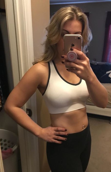 reviewer taking a mirror selfie while wearing a sports bra