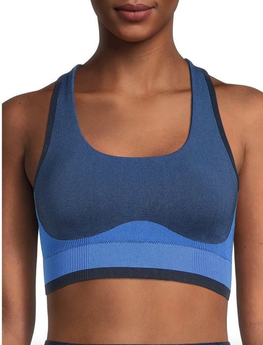 A person wearing a blue color-blocked sports bra
