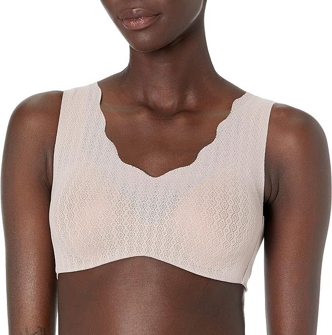 A person showcases a seamless bralette with scalloped edges