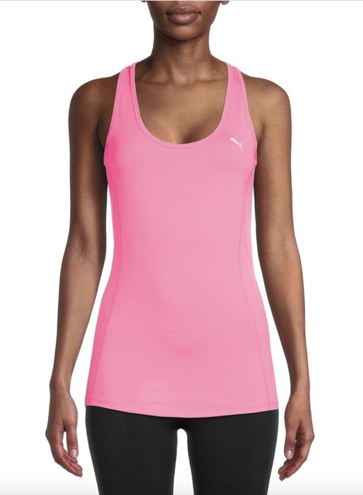 A person wearing a pink tank top paired with black leggings