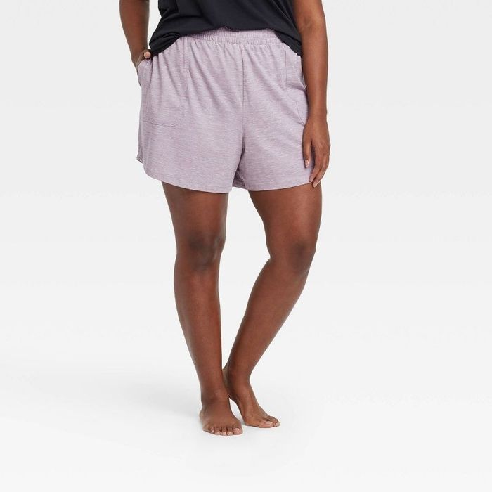 Model wearing the light gray mid-rise knit shorts