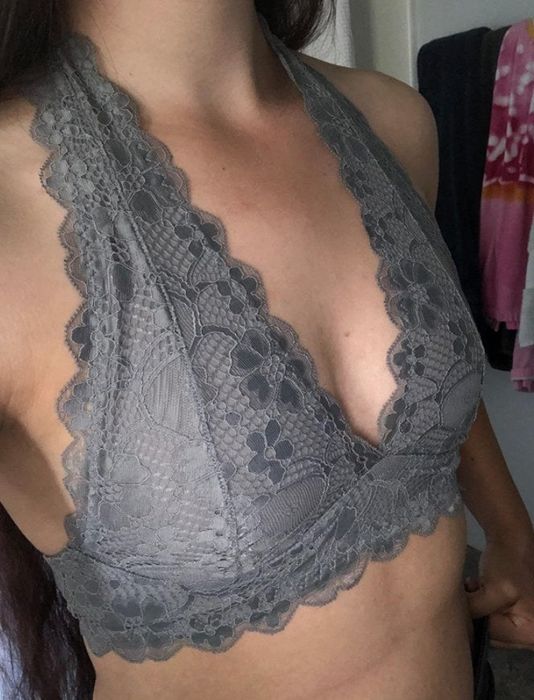 A reviewer is seen wearing a grey bralette