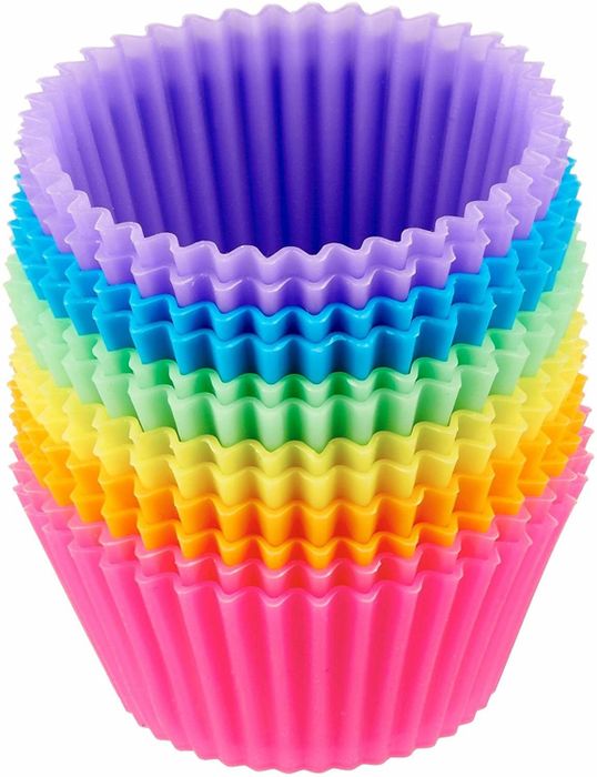 a stack of brightly colored silicone muffin cups in a rainbow pattern