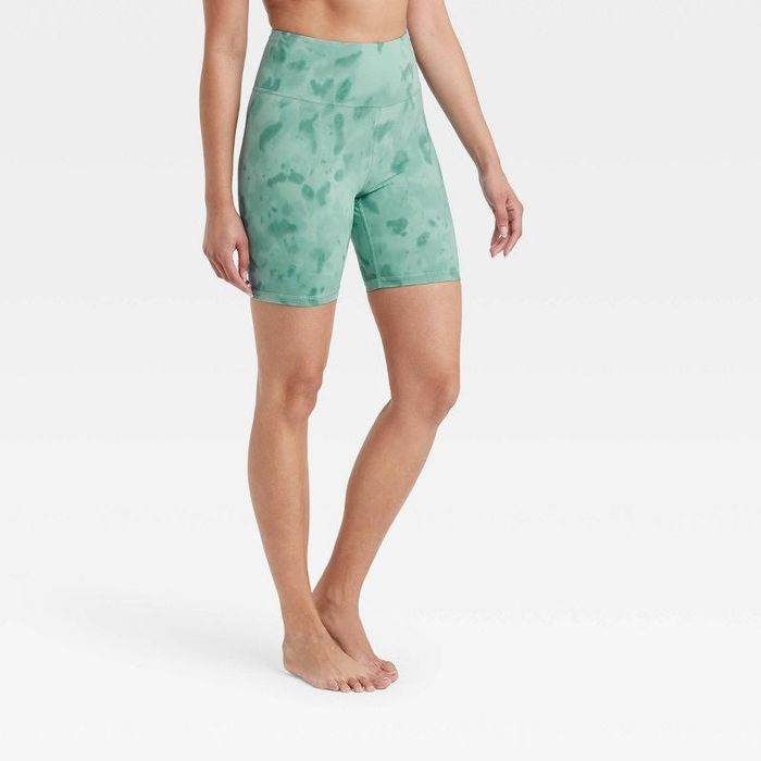 Model wearing the aqua green high-rise spray dye bike shorts