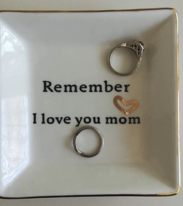 A jewelry dish that says 'remember, I love you mom,' with rings placed inside as a sweet reminder.