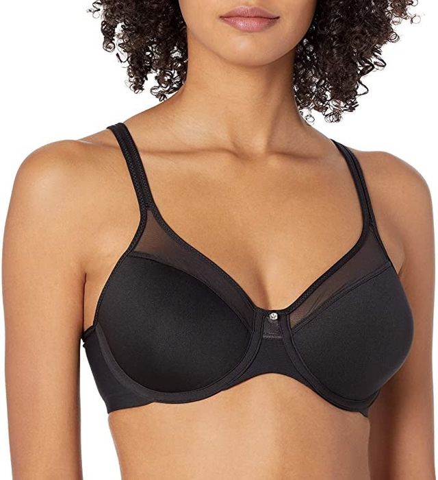 A model wearing a black bra with intricate mesh detailing
