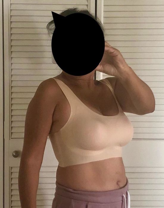 A reviewer's mirror selfie wearing the bra