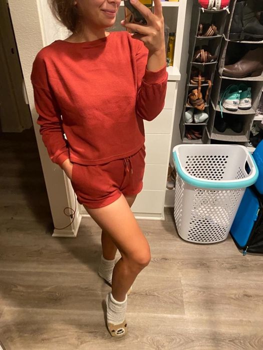 A photo from a reviewer featuring the pajamas in a vibrant red, highlighting the bold and cozy design.