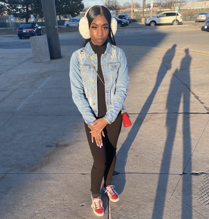 A reviewer wears white ear muffs, showcasing their cozy and chic design.