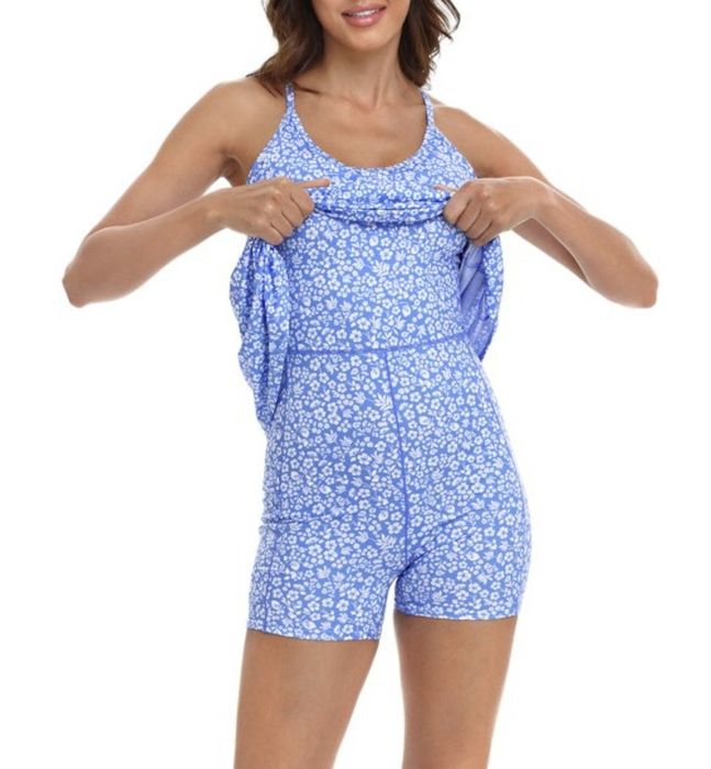 A person demonstrating the shorts underneath a blue and white workout dress