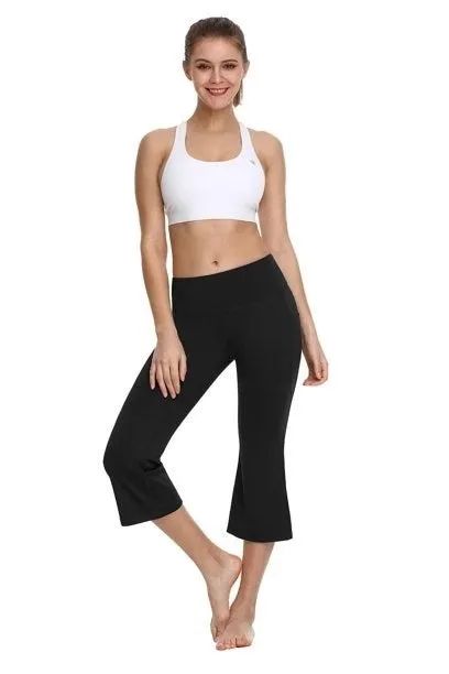 A model showcases black capri yoga pants paired with a crisp white sports bra.