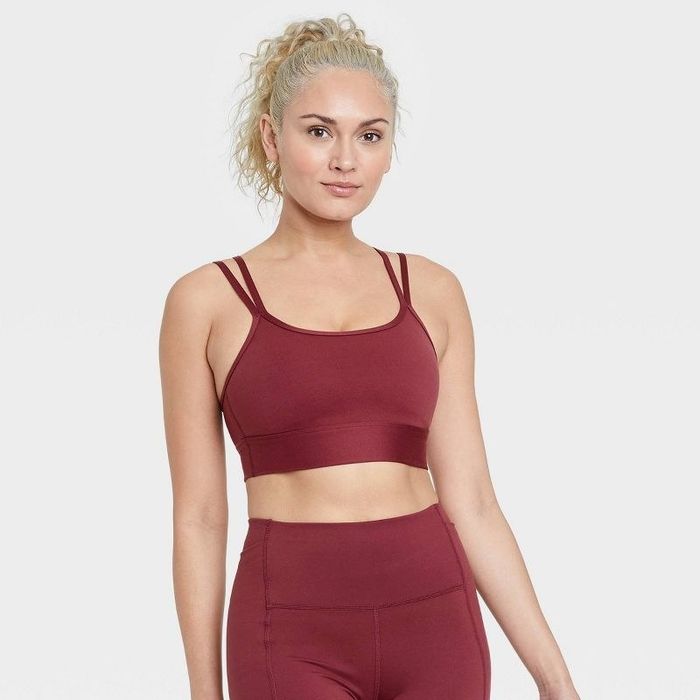 Model wearing the garnet red strappy light sports bra