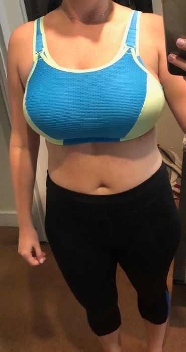 A reviewer's mirror selfie wearing the bra