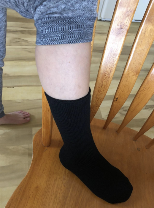 A reviewer showcases the comfort of wearing insulated socks.