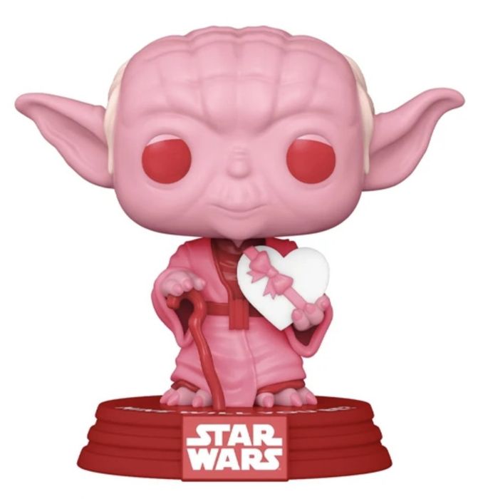 A Yoda figurine in pink and red, holding a sweet Valentine's Day chocolate heart.