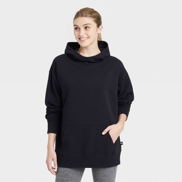 Model wearing the black oversized hooded sweater