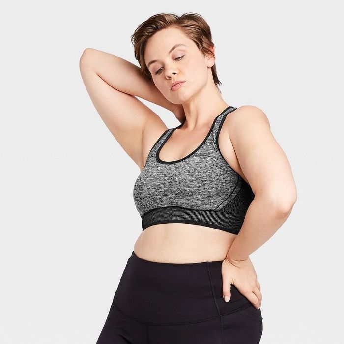 Model wearing the dark Heather gray racerback sports bra