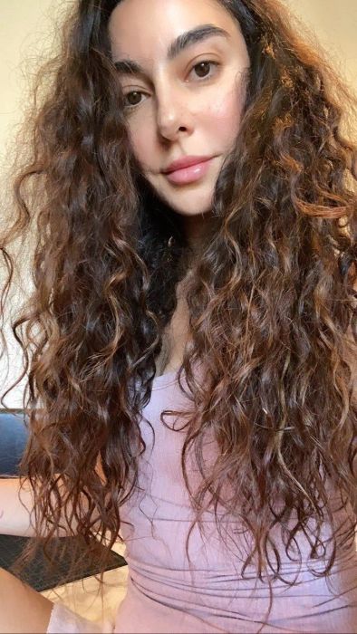 reviewer with thick, long, naturally curly hair