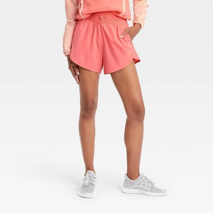 Model styling the rose pink high-rise drawstring shorts