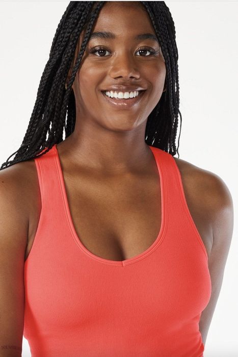 A person sporting a vibrant red tank top