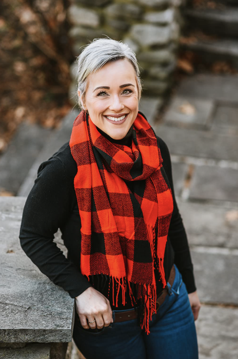 A reviewer demonstrates how to wear a scarf for both warmth and fashion.