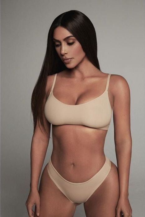 Kim Kardashian is pictured in a tan Skims bra and coordinating underwear
