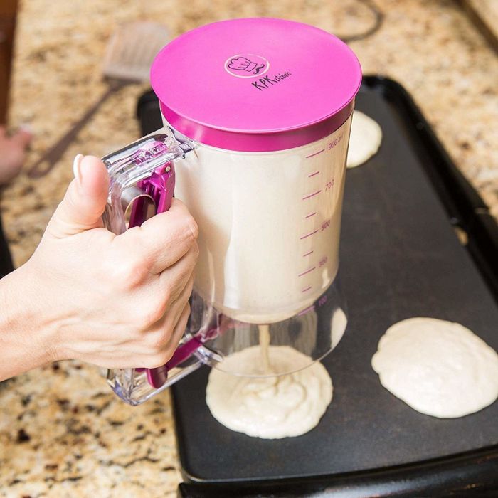 a model using the dispenser to form perfectly round pancakes on a griddle