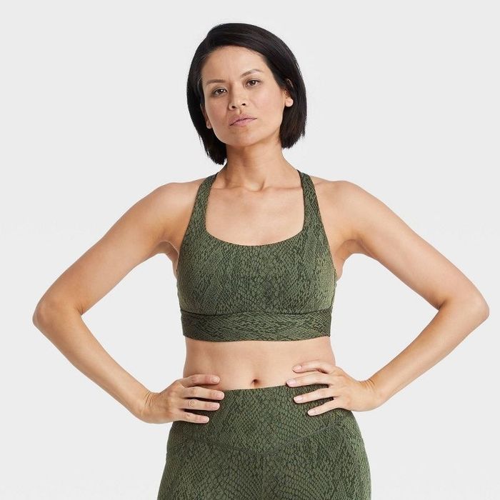 Model wearing the olive green snake print sports bra