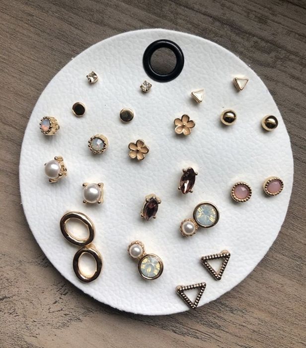 The full set of earrings neatly stored in a faux leather holder.