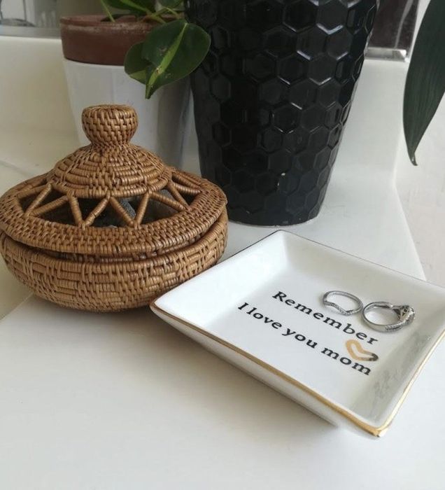 A jewelry dish that says, 'remember, I love you mom,' with rings nestled inside.