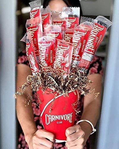 A person presenting a bouquet of flowers.